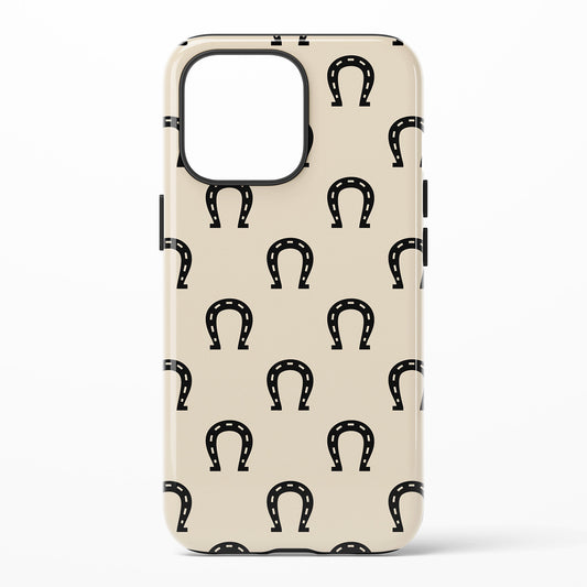 Phone case with black horse shoes on cream color background