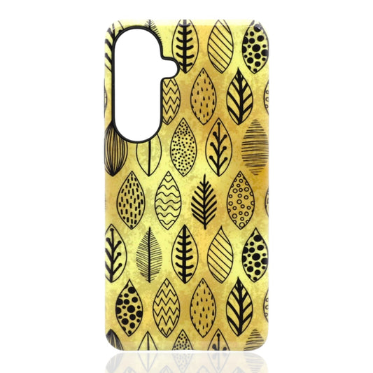 Phone case featuring stylized black leaves with geometric patterns on a golden‑yellow background